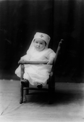 Rev. Martin's Baby Wearing Red Cross Hat, Anaheim. [graphic]