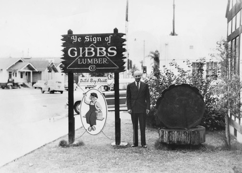 Oscar Gibbs Standing Next to the Gibbs Lumber Company Sign, Anaheim. [graphic]