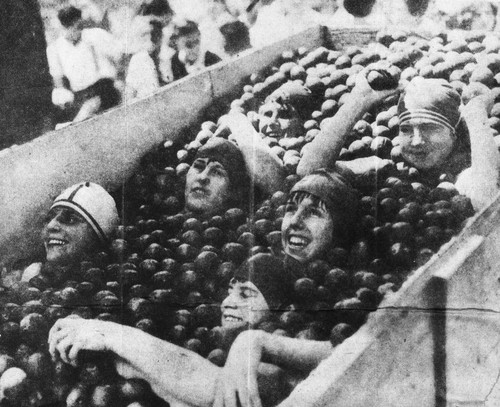 Miss Anaheim contestants swimming in oranges at City Park Pool, now Charles A. Pearson Park, on April 23, 1929. [graphic]