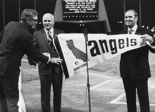 Anaheim Mayor Jack Dutton Accepts New California Angels Pennant from Gene Autry. [graphic]