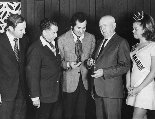 Mayor Pro Tem Adolph J. Schutte Presenting the Key to the City to Singing Star Trini Lopez, Anaheim. [graphic]