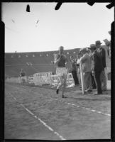 Track athlete at the finish line on the track at the Coliseum, Los Angeles, 1926