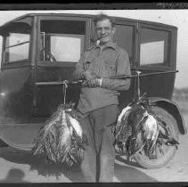 Man carrying dead birds