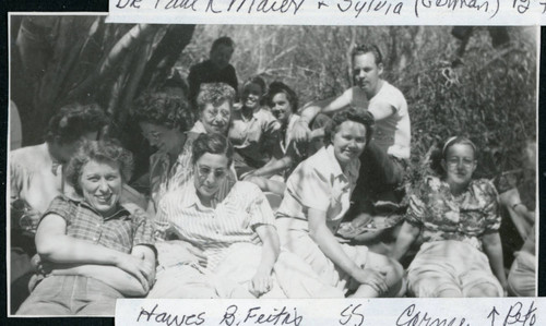 Photograph of a group of people including L. Josephine Hawes, B. Feitis, S.S. Corney and Pete Merritt sitting under trees near Manzanar