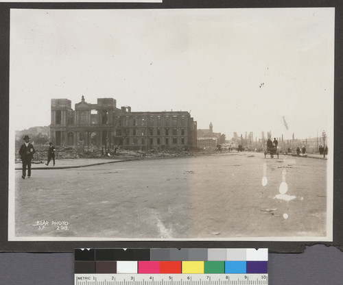 [Street scene at Van Ness Ave near Market St. Ruins of St. Ignatius Church and College, left.]