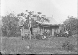 Group of African people in front of a chapel, Ricatla, Mozambique, ca. 1896-1911