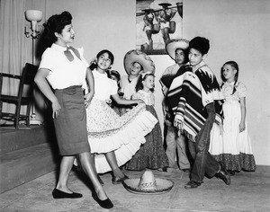 Maria Reyes performs the Mexico hat dance for a group of children