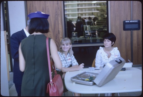 Freshmen at Welcome Day registration tables in front of Galbraith Hall