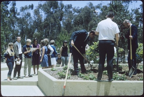 Carl Eckart and student from the class of 1968 plant a tree