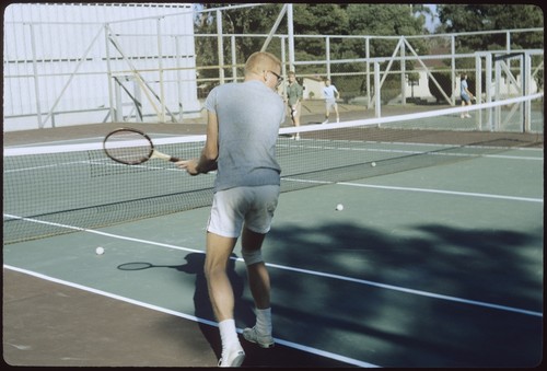 Students playing tennis on Matthews campus tennis courts