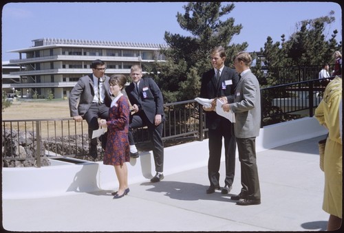 Students pass out information flyers, Mayer Hall in the background