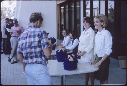 Freshmen at Welcome Day registration tables in front of Galbraith Hall