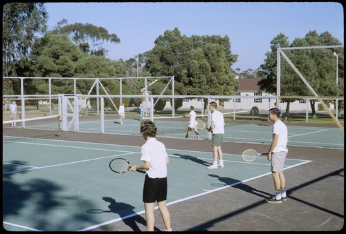 Students playing tennis on Matthews campus tennis courts