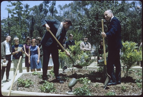 Carl Eckart and student from the class of 1968 plant a tree