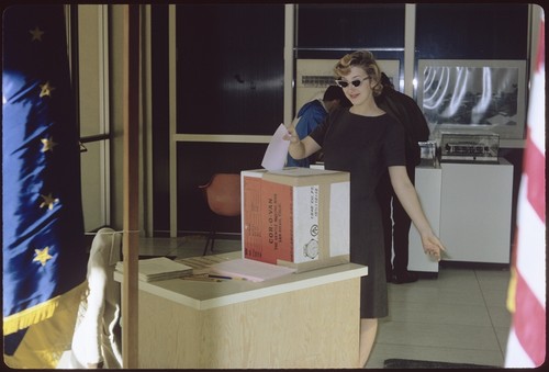 Student turning in her vote