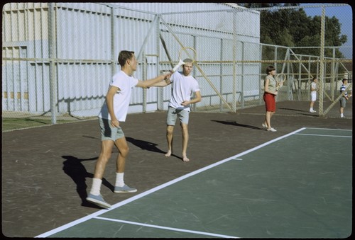 Students playing tennis on Matthews campus tennis courts