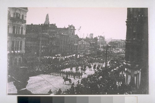 Parade on Market Street, taken from O'Farrell. Chimneys of the U.S. Mint; tower on California Pioneers Hall; Dr. George's Museum of Anatomy; Phelan Building on right. 1895