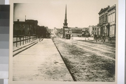 Between O'Farrell & Geary Streets on Taylor St., 1867. Plymouth Congregational Church (spire), center. Plank sidewalk. [T.E. Hecht.]