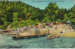 Russian River, California with bathers and boaters and sunbathers on the beach with sun umbrellas, 1930s