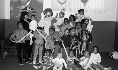 Children posing with a clown, Los Angeles