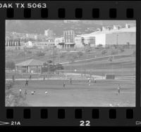 Kids playing baseball in Pan Pacific Park with Pan Pacific Auditorium in background Los Angeles, Calif., 1986