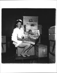 Betsy Olmsted Ashman with basket of eggs and an issue of the Argus Courier, Petaluma, California, 1955