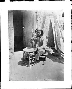 Zuni Indian making wampum, ca.1898