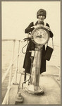 [Woman posing next to ship's telegraph on deck, SS Admiral Farragut?]]