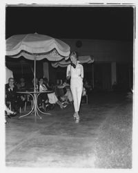 White leisure pants and matching white, long-sleeved blouse modeled at the Sword of Hope fashion show at the Flamingo Hotel, Santa Rosa, California, June 18, 1960