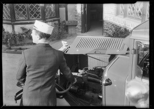 Man putting oil in car, Southern California, 1931
