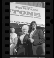 Dolly Parton and Sylvester Stallone arriving at benefit showing of motion picture "Rhinestone" in Los Angeles, Calif., 1984