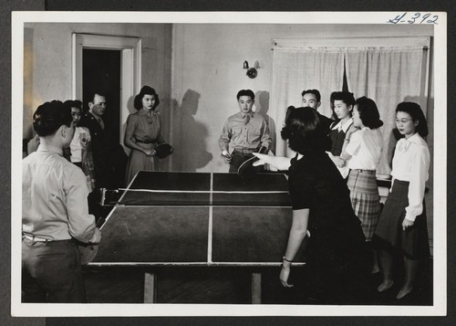 Table tennis or ping-pong is a popular game with the settlers. Shown here are four near experts at the game. The scene was caught at the Young Kansas Citians' Club. Kansas City, Missouri