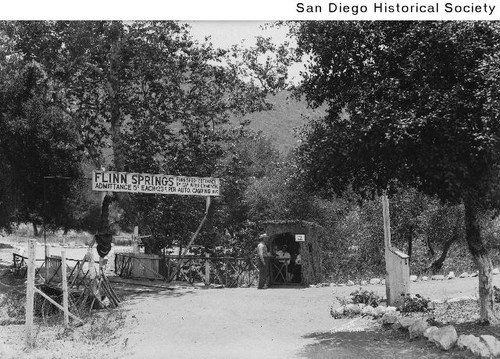 A man standing by a booth at the entrance to Flinn Springs