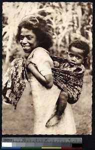 Sister carries little brother on her back, New Caledonia, ca.1900-1930