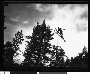 Ski jumping at Big Pines Recreation Camp, viewed from beneath the skier, 1929