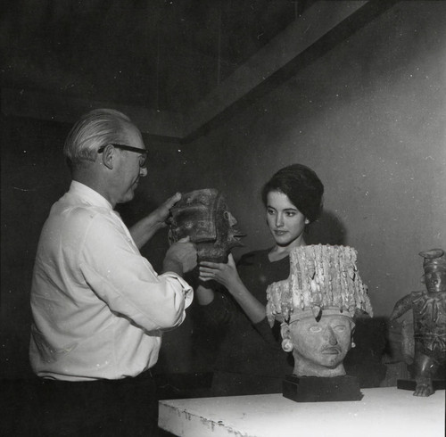 Woman and man with sculptures, Scripps College