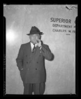 William Bioff smoking in front of Superior Court where he was indicted for tax evasion, Los Angeles, 1939