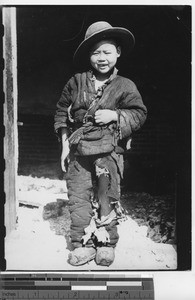 A boy in ripped clothing at Fushun, China, 1941