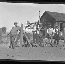 A hunting club posed with guns