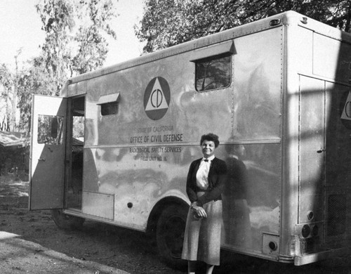 Dr. Marge Anthony standing next to the civil defense vehicle
