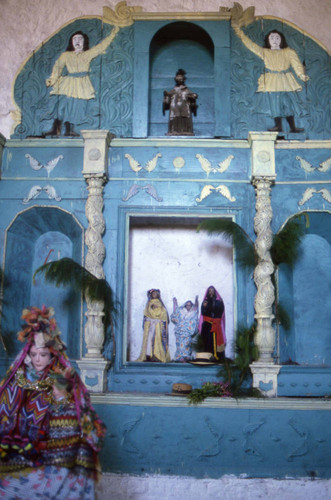A colorful altar with religious statues and imagery, Chajul, 1982