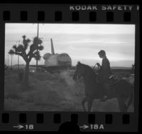 Boy on horseback watching the Space Shuttle Enterprise being towed across Antelope Valley, Calif., 1977