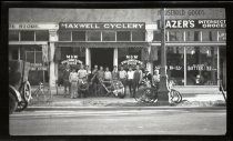Men posing outside Maxwell Cyclery, Bisceglia Building