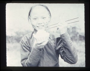 Young Chinese person eating rice with chopsticks, Changde, Hunan, China, ca.1900-1919