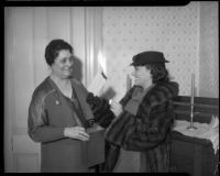 Actress Gloria Swanson and Minnie Barton burn the mortgage to the Bide-A-Wee home for working mothers, Los Angeles, 1935