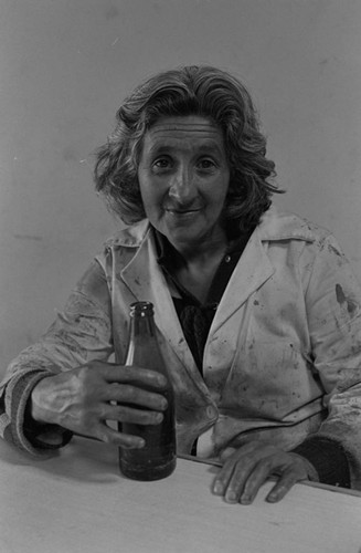 A woman and a bottle, Tunjuelito, Colombia, 1977