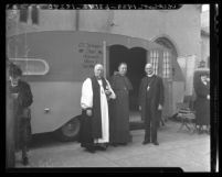 Bishops standing before St. Christopher Catholic Church's Chapel Trailer, Calif., 1940