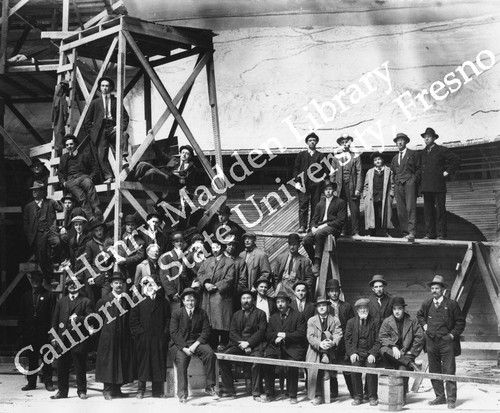 Workmen and office personnel in front of Lincoln Highway exhibit