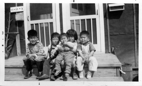 Florin children in Jerome Relocation Center sitting outside barracks