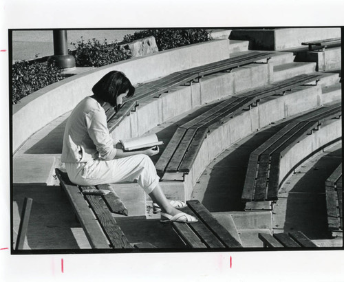 Student studying in the amphitheater on Malibu campus, early 1980s